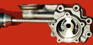 Drilling oil pump passageways oversize, also grind off sharp corners